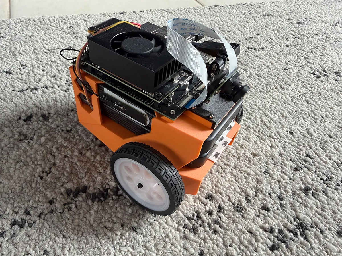 An orange JetBot with a Jetson Orin Nano on top